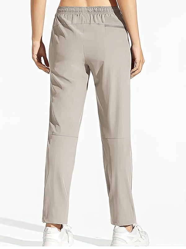 Women's waterproof quick-drying hiking pants with pockets, elastic waist, and 4-way stretch fabric for outdoor activities.